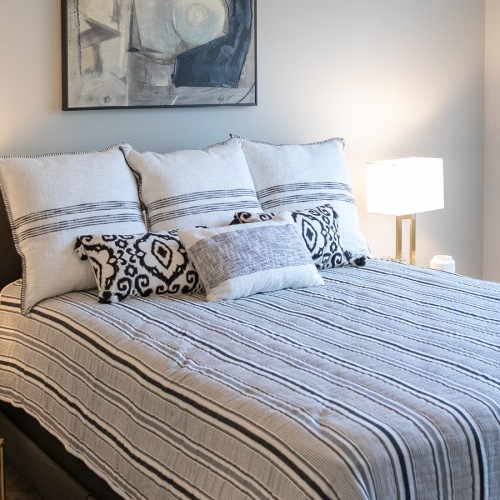 Cozy Bedroom with Ceiling Fan, Large Window, and Plush Carpet at Sanctuary at Powell Place